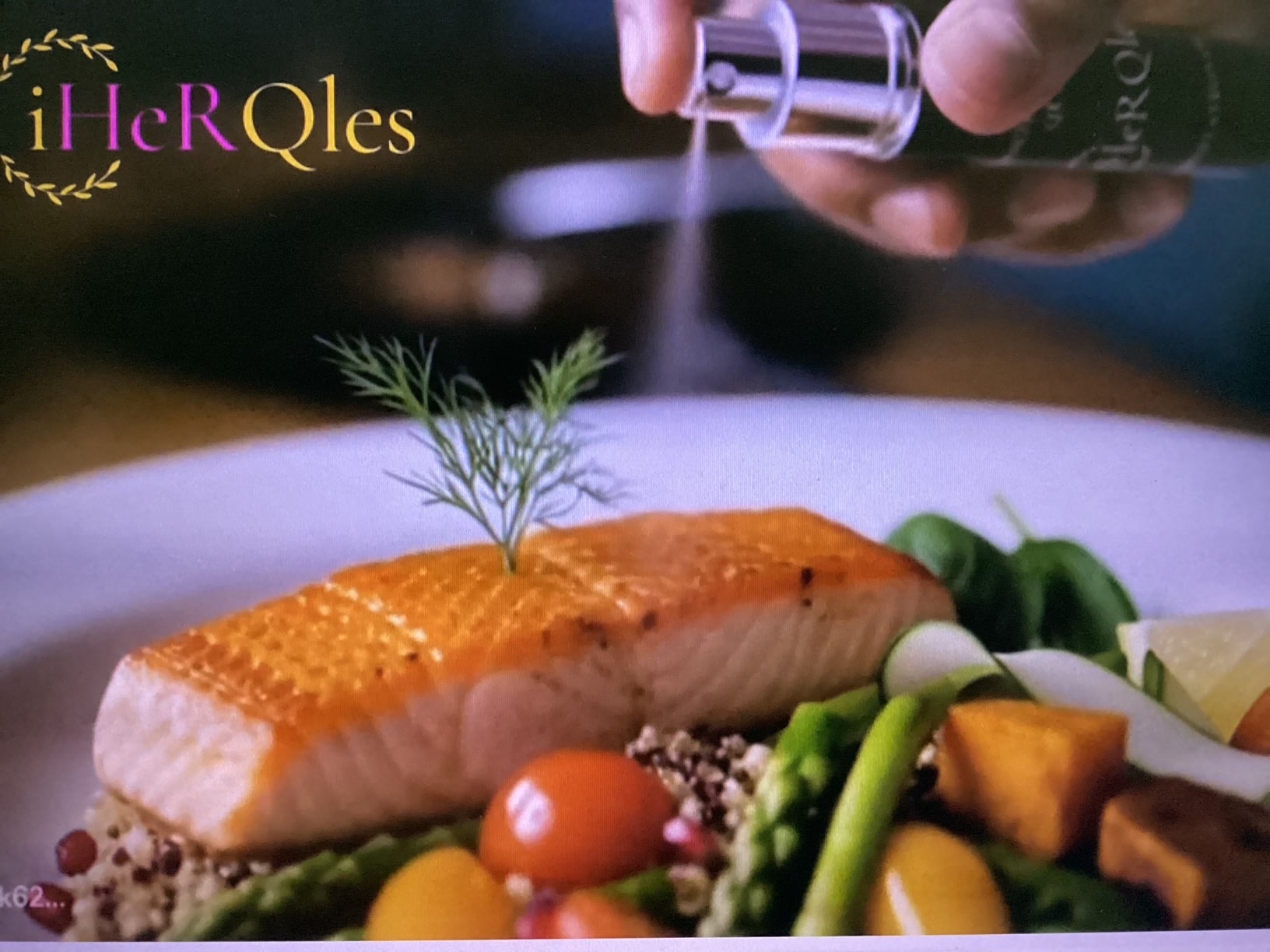 iHerQles Quantum Spray being sprayed on a salmon and vegetable dish