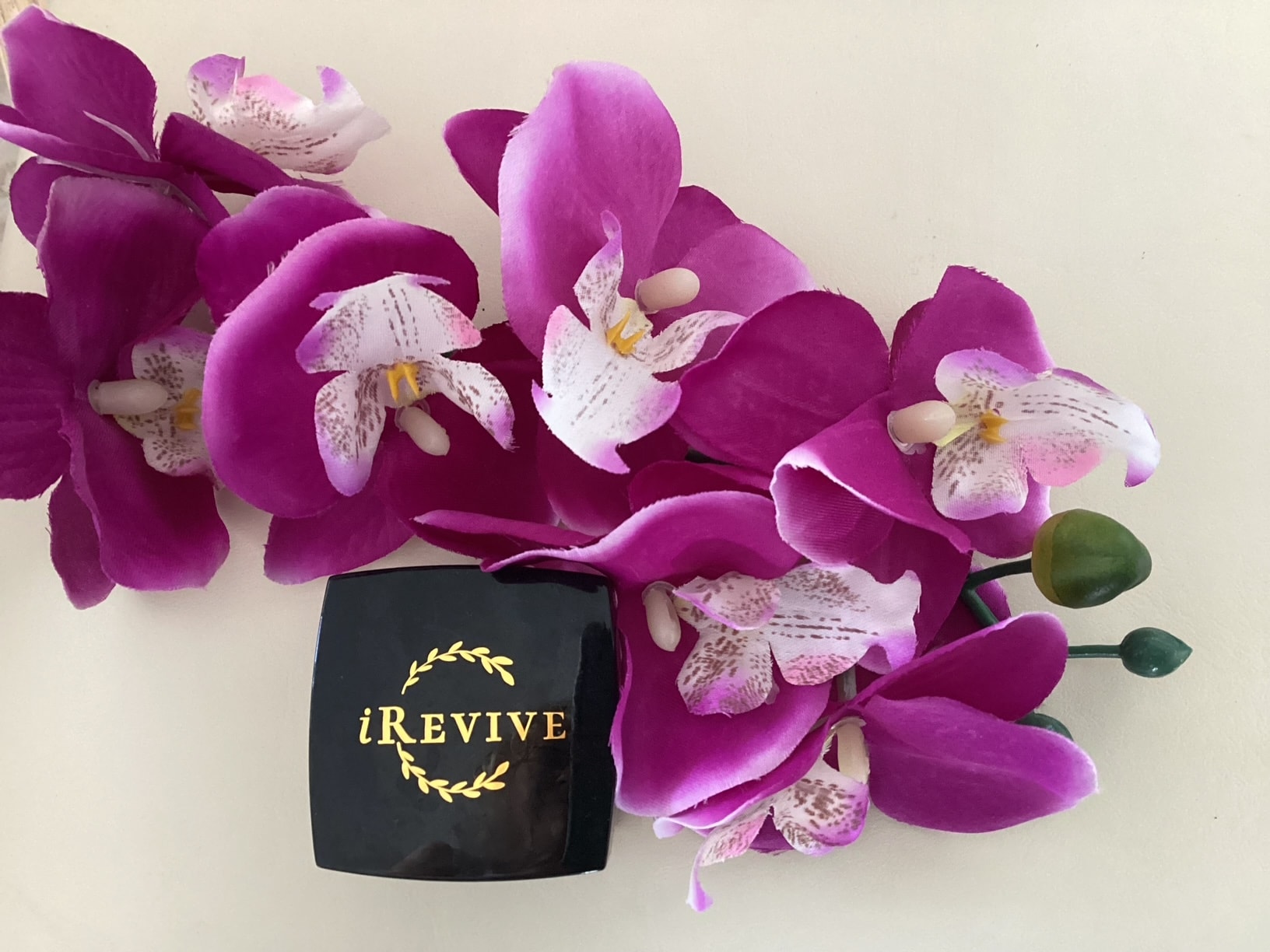 Quantum iRevive Skin Cream jar with magenta orchids